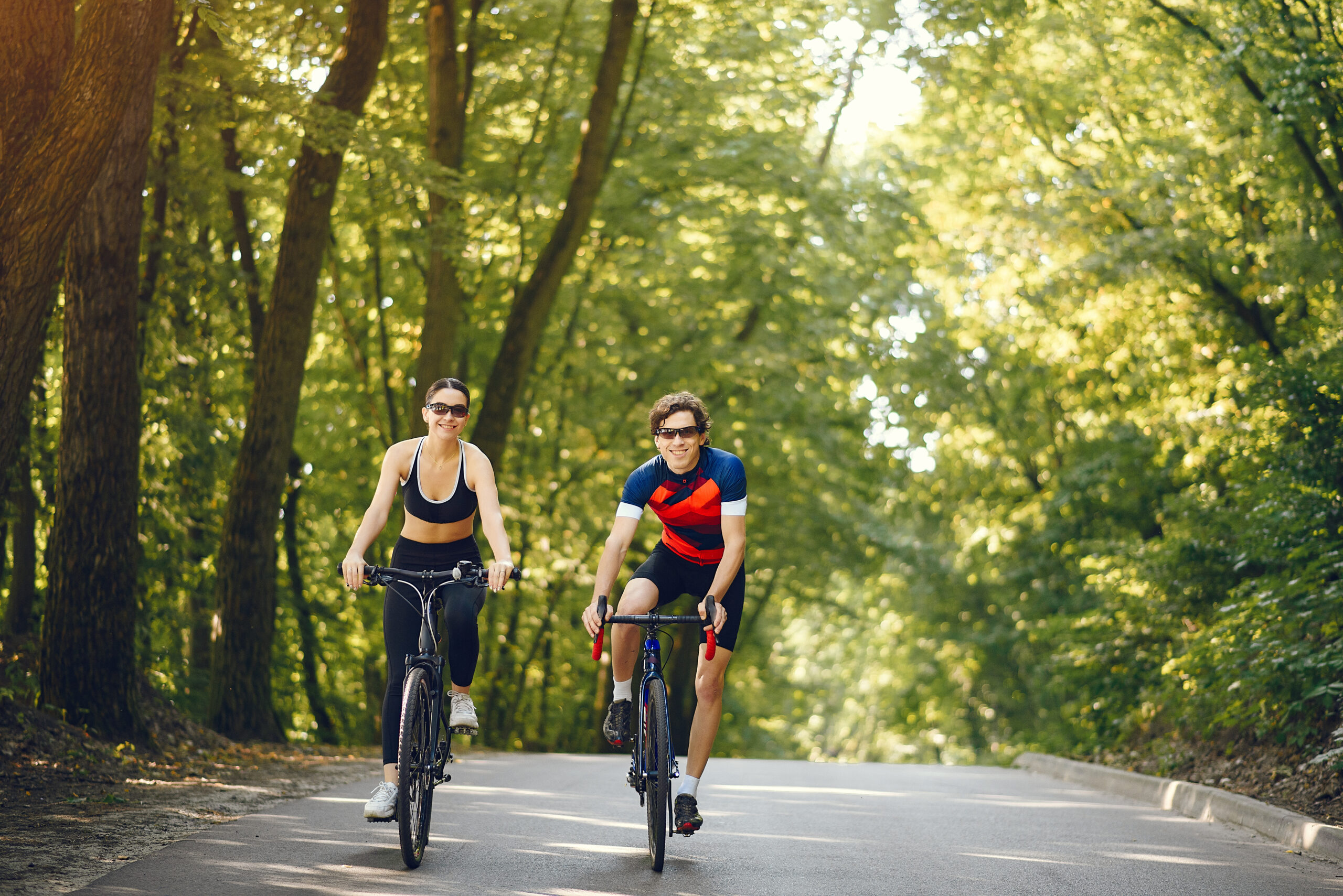 People with a bikes. Couple in a forest. Morning bike ride.
